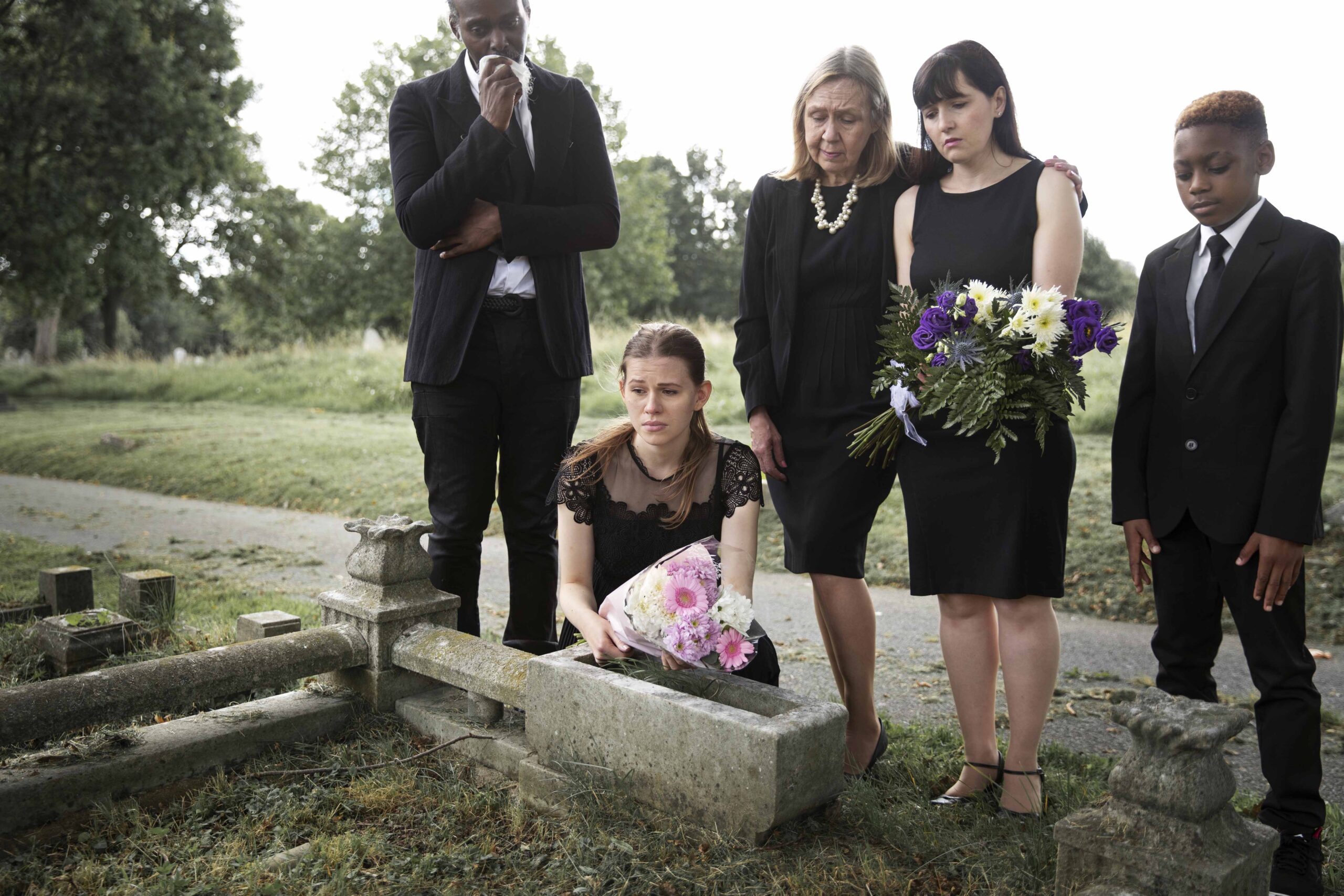 family visiting grave loved one